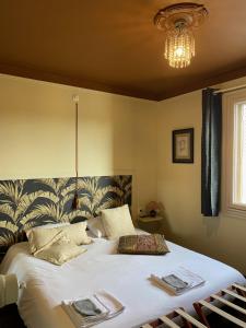 a bedroom with a large bed with towels on it at La Bouchère 33 in Meuzac