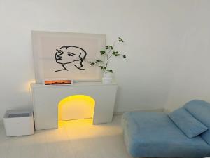 a living room with a blue couch and a table at 정담 신도림역 투룸 무료주차 in Seoul