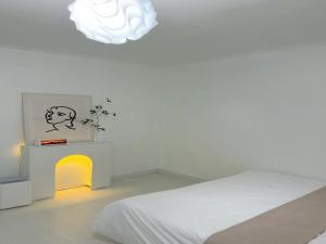 a bedroom with a bed and a table and a chandelier at 정담 신도림역 투룸 무료주차 in Seoul