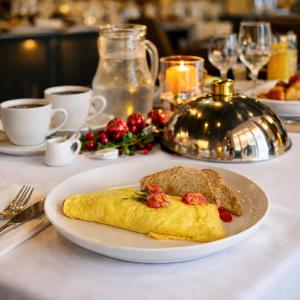 a plate with an omelet and toast on a table at La Dukes Resort in Bushman Rock