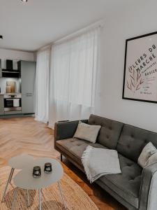a living room with a couch and a table at Batu Apartment in Viernheim
