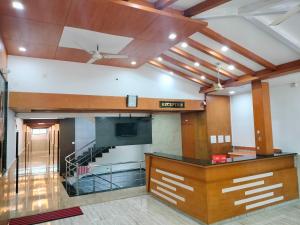 a large room with a staircase in a building at Hotel Jaganmatha Kollur in Kollūru