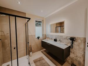 a bathroom with a sink and a shower at Batu Apartment in Viernheim +62 photos
