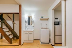 a small kitchen with a sink and a refrigerator at YAGARA TERRACE HOUSE OSAKA Room D in Osaka