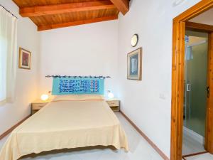 a bedroom with a bed with a blue headboard at Residence Approdo Verde in San Teodoro