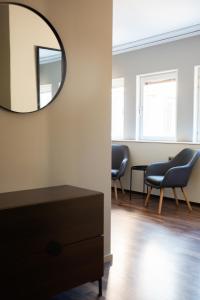 a dressing room with a mirror and a chair at Hotell City in Härnösand
