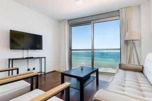 a living room with a couch and a table at Yourhouse Blau Blue 2 3 in Can Picafort