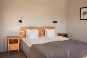 a bedroom with a large bed with two night stands at Hotell City in Härnösand +15 photos