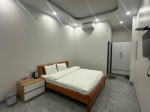 a bedroom with a bed in a room with lights at Trần Hưng Đạo 186 in Na Ngô