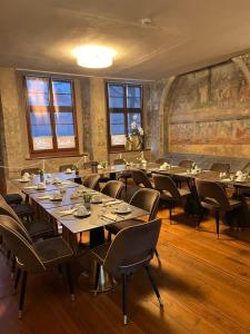 a large room with tables and chairs in it at Hotel Schwibbogen Altstadt & Apartments in Görlitz