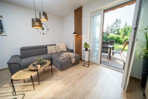 a living room with a couch and a table at Apartmány Na Satině in Malenovice