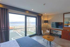 a hotel room with a bed and a large window at Best Western Plus Sapanca in Sapanca