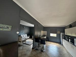 a room with a kitchen and a living room at Kort a Moi in Lichtenburg +8 photos