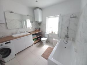 a white bathroom with a sink and a toilet at Ancuty 20 in Ancuty +38 photos