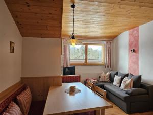 a living room with a couch and a table at Ferienhof Mittermair in Vorderstoder