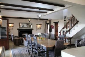 a dining room and living room with a table and chairs at Elands Bay Beach Villa in Elands Bay