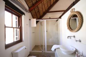 a bathroom with a glass shower and a sink at Elands Bay Beach Villa in Elands Bay +37 photos