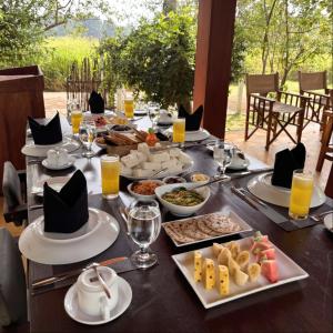 a long table with food and drinks on it at Tribe Wilpattu - Eco Lodge in Wilpattu