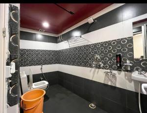 a bathroom with a toilet and a sink at Namaste Benares Varanasi in Varanasi +17 photos