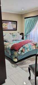 a bedroom with a bed and a window at Le Clus Stay in Bloemfontein