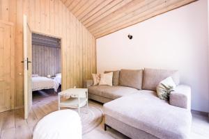 a living room with a couch and a table at La Playa Resort & Camp Trzebinia in Trzebinia +83 photos