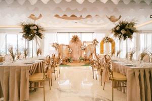 a banquet hall with tables and chairs with flowers at PlayaLolita Beach Resort in Calatagan +81 photos