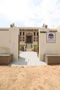a large building with two gates in front of it at Haveli Kesar Vilas in Chāran ki Dhāni