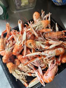 a pile of lobsters on a tray on a table at The Lovecroft Guest House in Laide