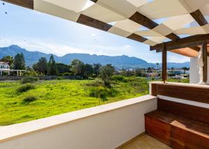 a balcony with a view of a green field at Delux SeaSide Victorious Villa by HolidayKeys in Kyrenia