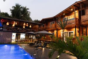 a resort with a swimming pool and a building at Tranquillo By The Beach, Candolim in Candolim