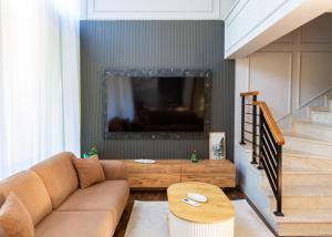 a living room with a couch and a tv at Delux SeaSide Victorious Villa by HolidayKeys in Kyrenia +15 photos