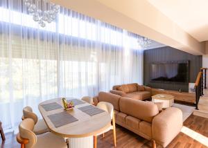 a living room with a couch and a table at Delux SeaSide Victorious Villa by HolidayKeys in Kyrenia