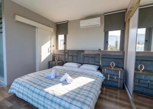 a bedroom with a bed with two towels on it at Delux SeaSide Victorious Villa by HolidayKeys in Kyrenia