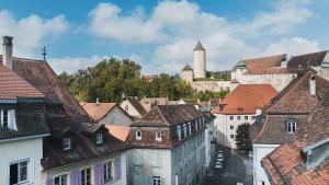 a view of a city with a castle in the background at Hostellerie des Princes-Evêques - Le Mystère in Porrentruy