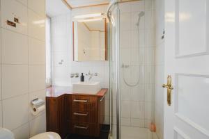 a bathroom with a toilet and a sink and a shower at Hostellerie des Princes-Evêques - Le Mystère in Porrentruy +15 photos