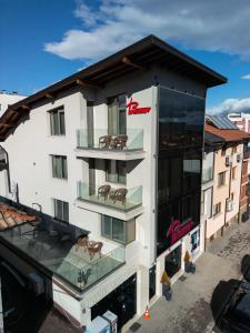 a building with a balcony with tables on it at Apartments Polejanov in Razlog
