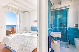 a bedroom with a bed and a tub and a sink at Villino Gelli in Follonica +41 photos