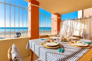 a dining room with a table with a view of the ocean at Villino Gelli in Follonica