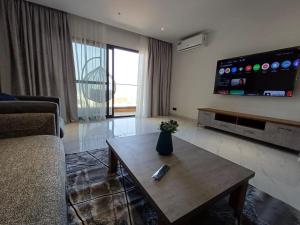 a living room with a couch and a coffee table at Ocean Waves Yoff Virage in Dakar