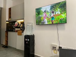 a flat screen tv hanging on a wall in a kitchen at Thesh Home at Tsavo Sunset 2 ,Thindigua Kiambu Road in Kiambu