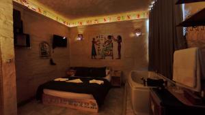a bathroom with a bed and a bath tub at Pyramids Mystery Inn in Cairo