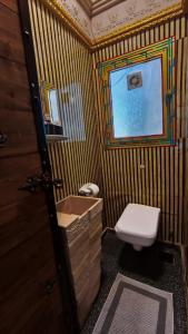 a bathroom with a toilet and a sink and a window at Pyramids Mystery Inn in Cairo