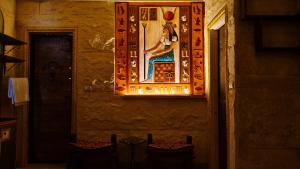 a painting of a woman on the wall of a room at Pyramids Mystery Inn in Cairo +45 photos