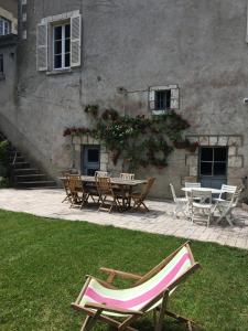 a group of chairs and tables in front of a building at Villa Theodora in Blois