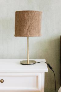 a lamp sitting on top of a white table at Katrina Summer House in Jūrmalciems