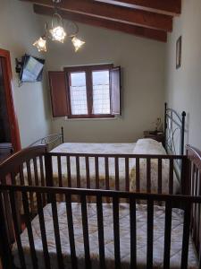 a bedroom with a bed with a crib at Borgo degli Ulivi in Morcone