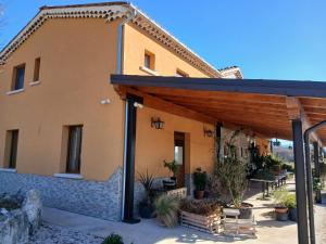 a building with a wooden roof and a patio at Borgo degli Ulivi in Morcone