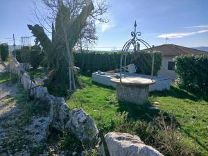 a garden with a bird bath in the grass at Borgo degli Ulivi in Morcone