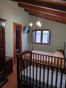 a bedroom with a wooden crib in a room at Borgo degli Ulivi in Morcone