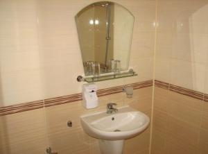 a bathroom with a sink and a mirror at Hotel Boyanovi in Bansko